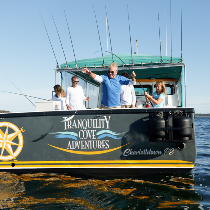 a man riding on the back of a boat in a body of water