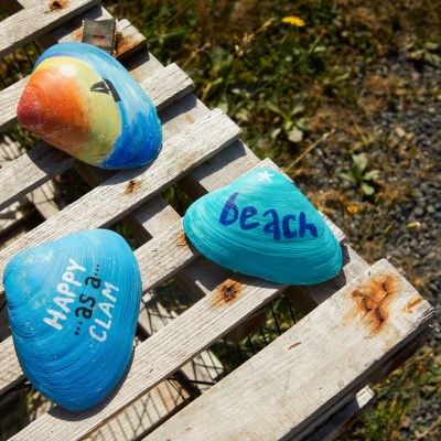a slice of pizza sitting on top of a wooden bench