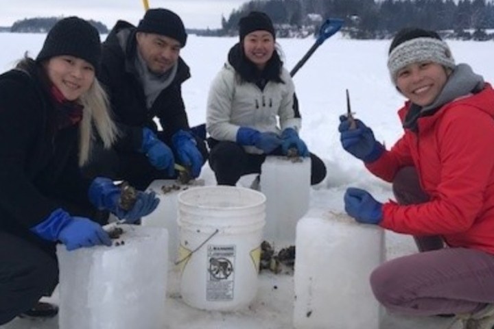a group of people sitting in the snow